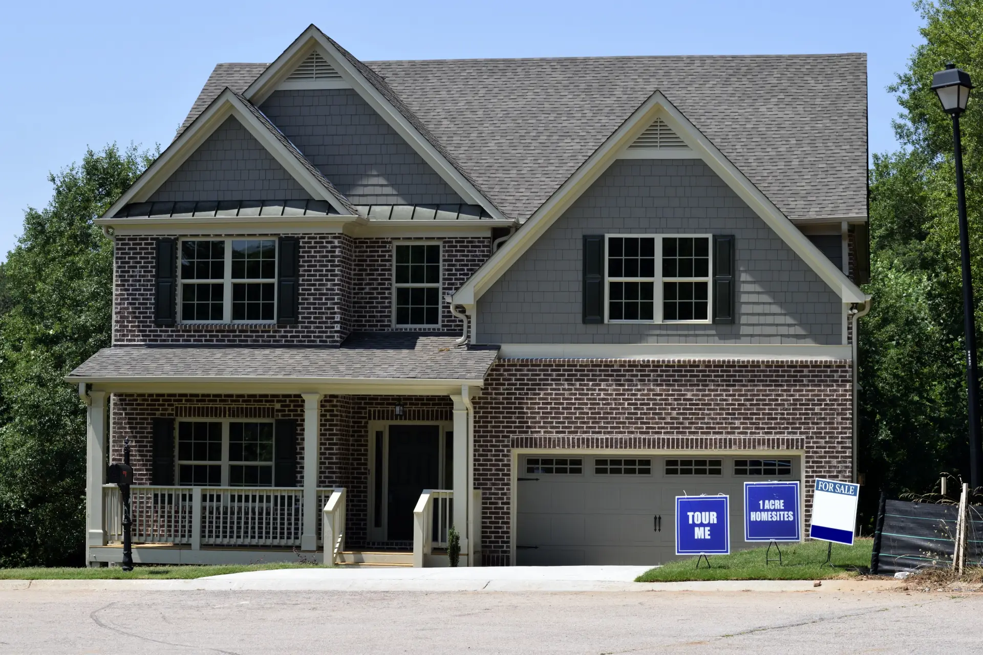 brick and gray house with signs symbolizing real estate law